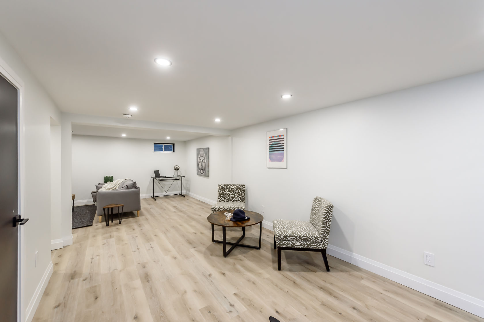 Bright finished basement with beautiful wood flooring and professional staging — premium portfolio shot — Gateshead, Hamilton | MTC Renovations